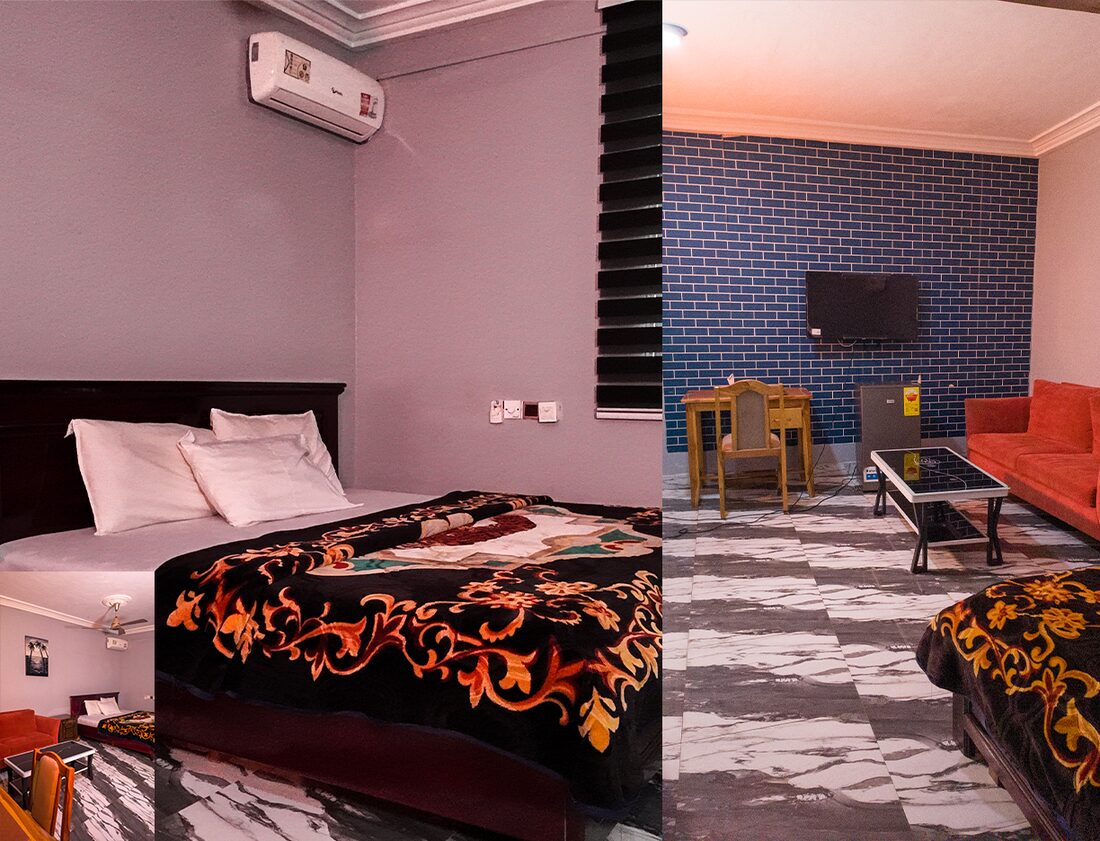 GHS250 room with a queen size bed, air conditioner, TV, fridge, desk and sofa